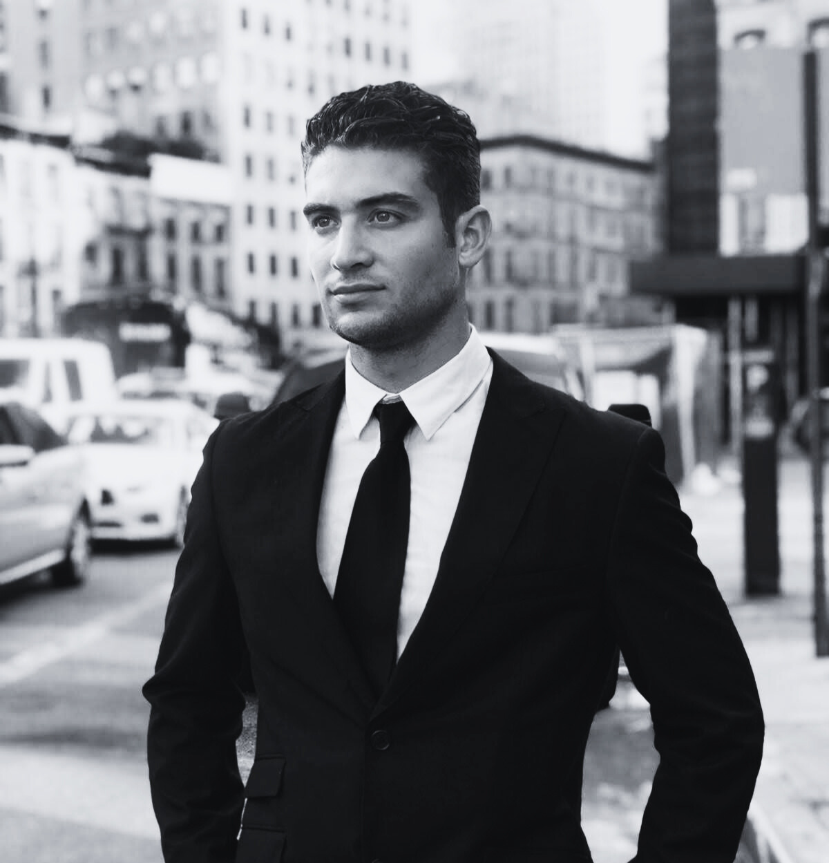 Medium black-and-white portrait of Franky Huerta in a suit — minimalist, grounded, and composed expression.